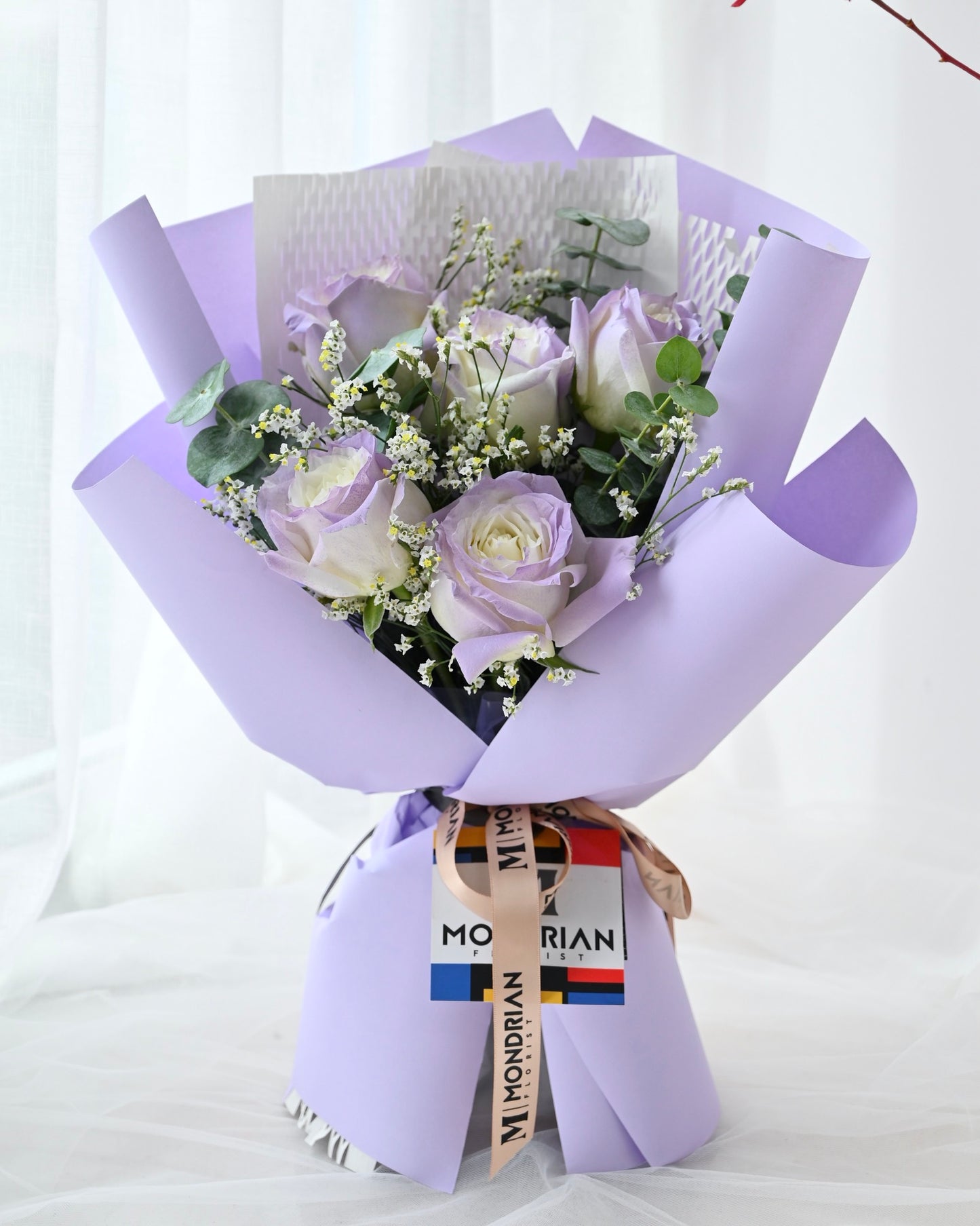 a bouquet of lilac rose bouquet with limonium flower bouquet by Mondrian Florist