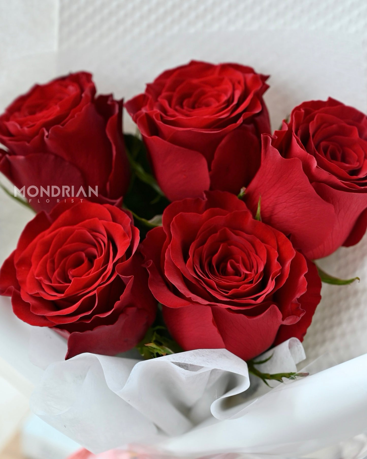 a bouquet of pure red roses by Mondrian Florist