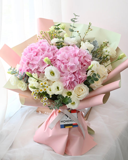a fresh flower bouquet with pink hydragea and white flowers by Mondrian Florist SG