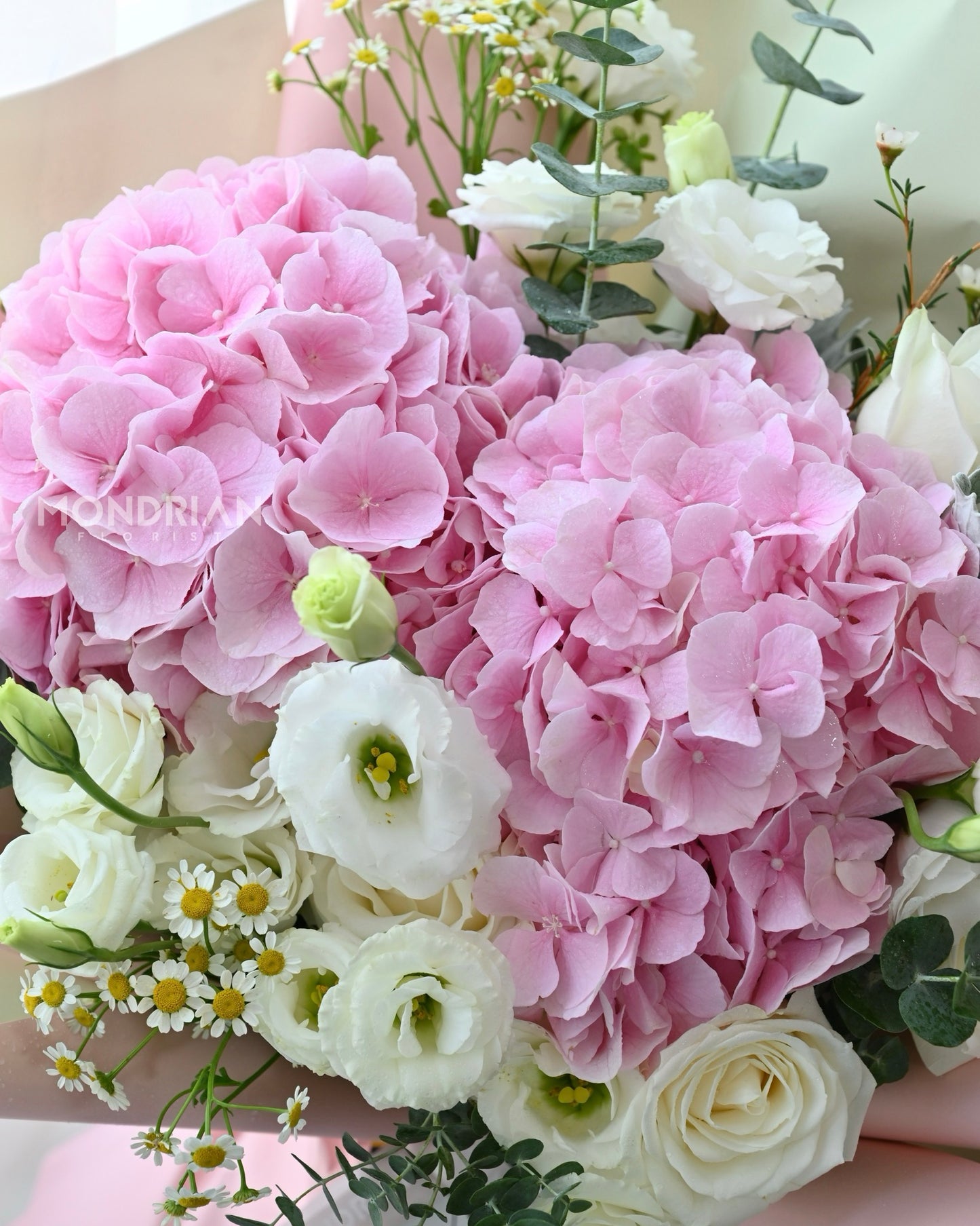 close up of a fresh flower bouquet with pink hydragea and white flowers by Mondrian Florist SG