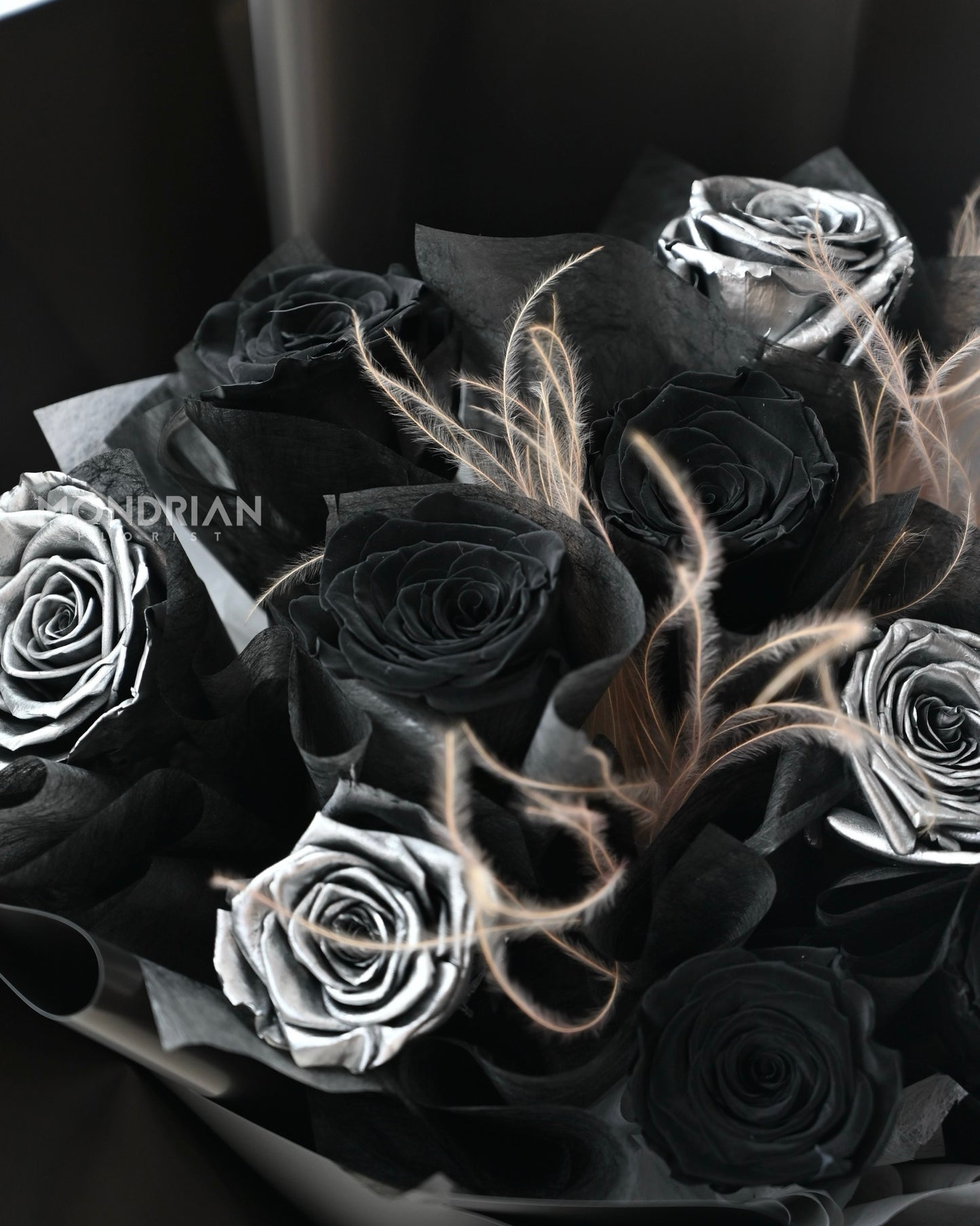 close up of a bouquet with preserved black and silver roses