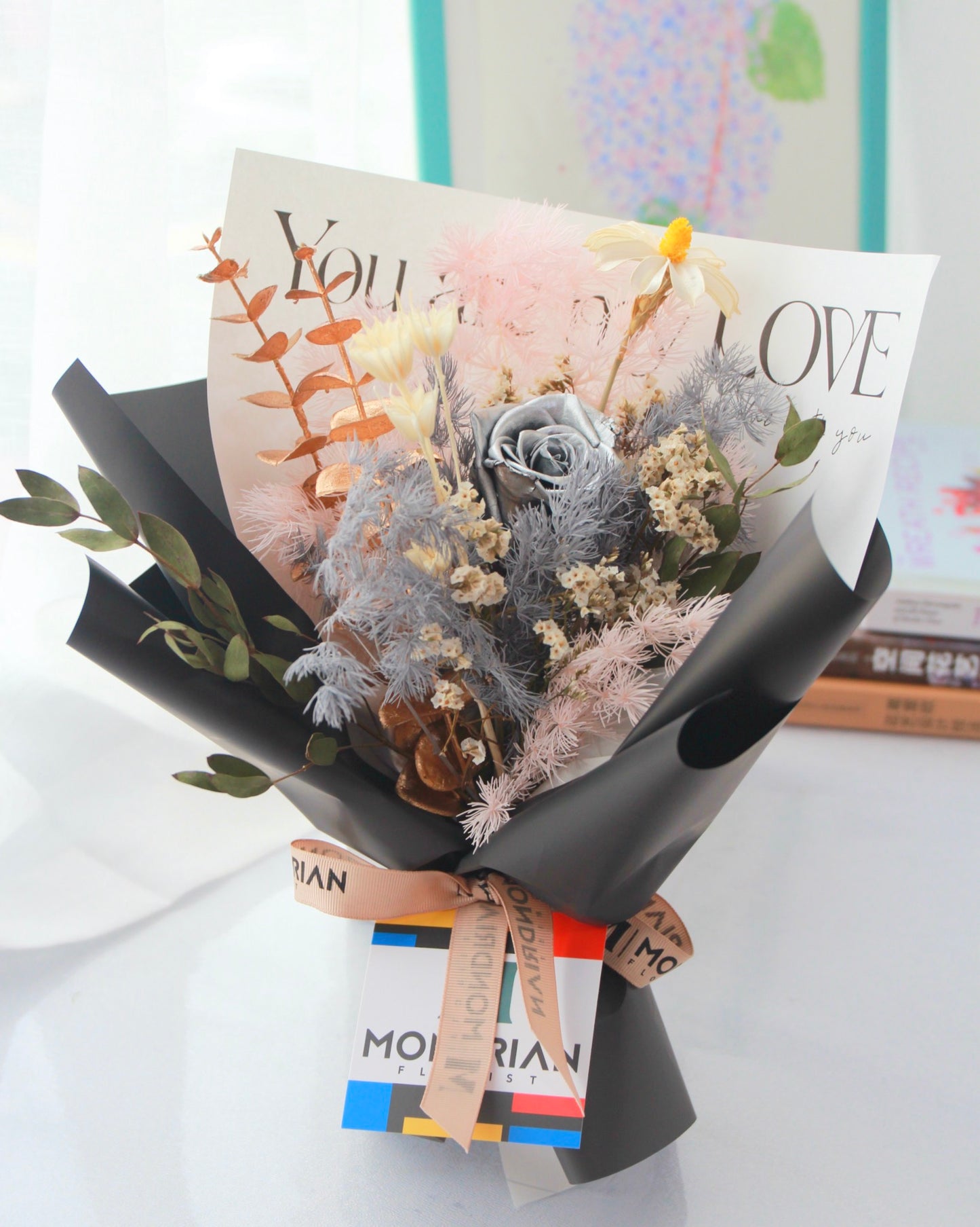 a flower bouquet with preserved silver rose and dried flowers
