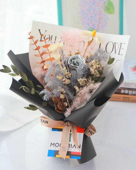 a flower bouquet with preserved silver rose and dried flowers