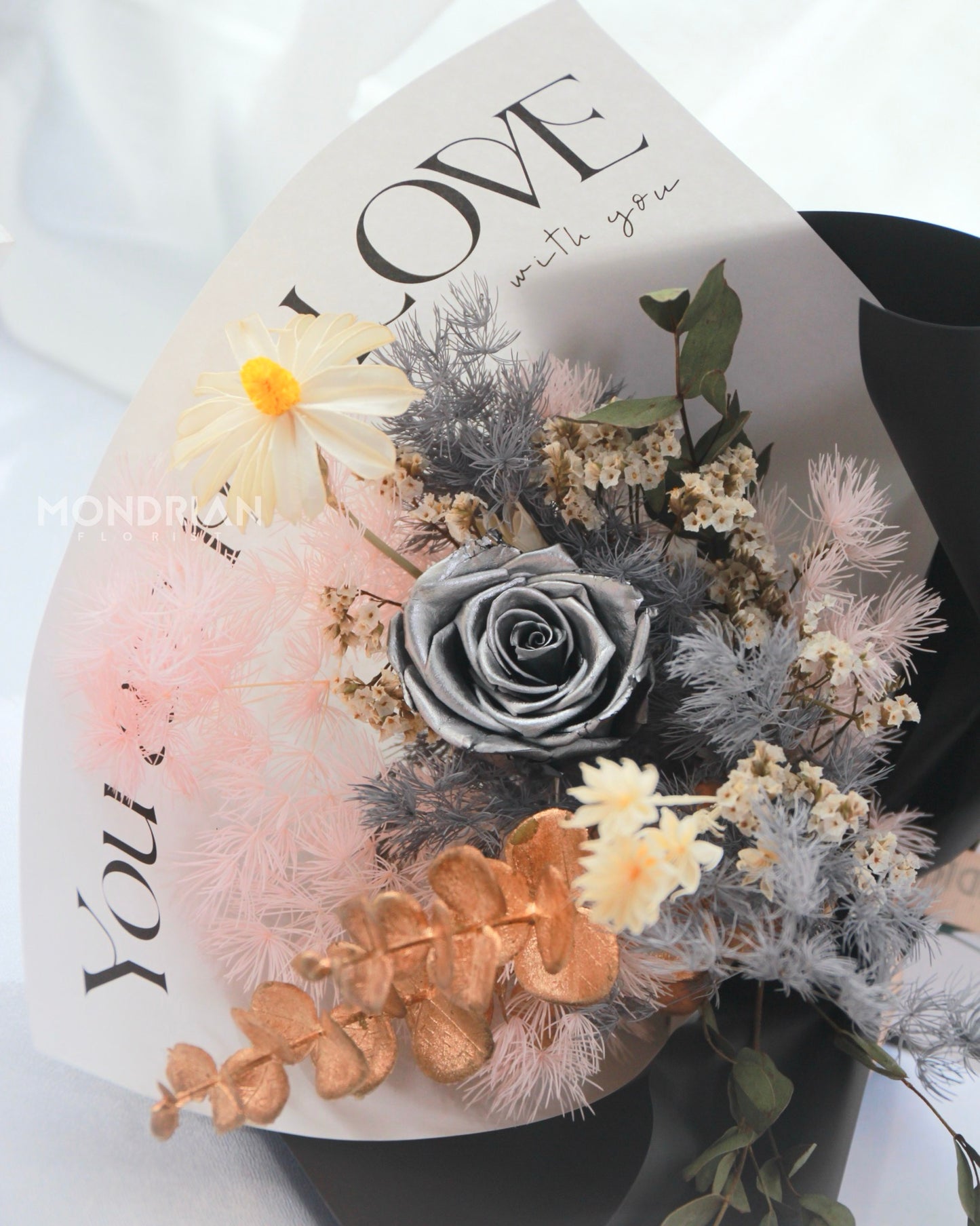 a flower bouquet with preserved silver rose and dried flowers
