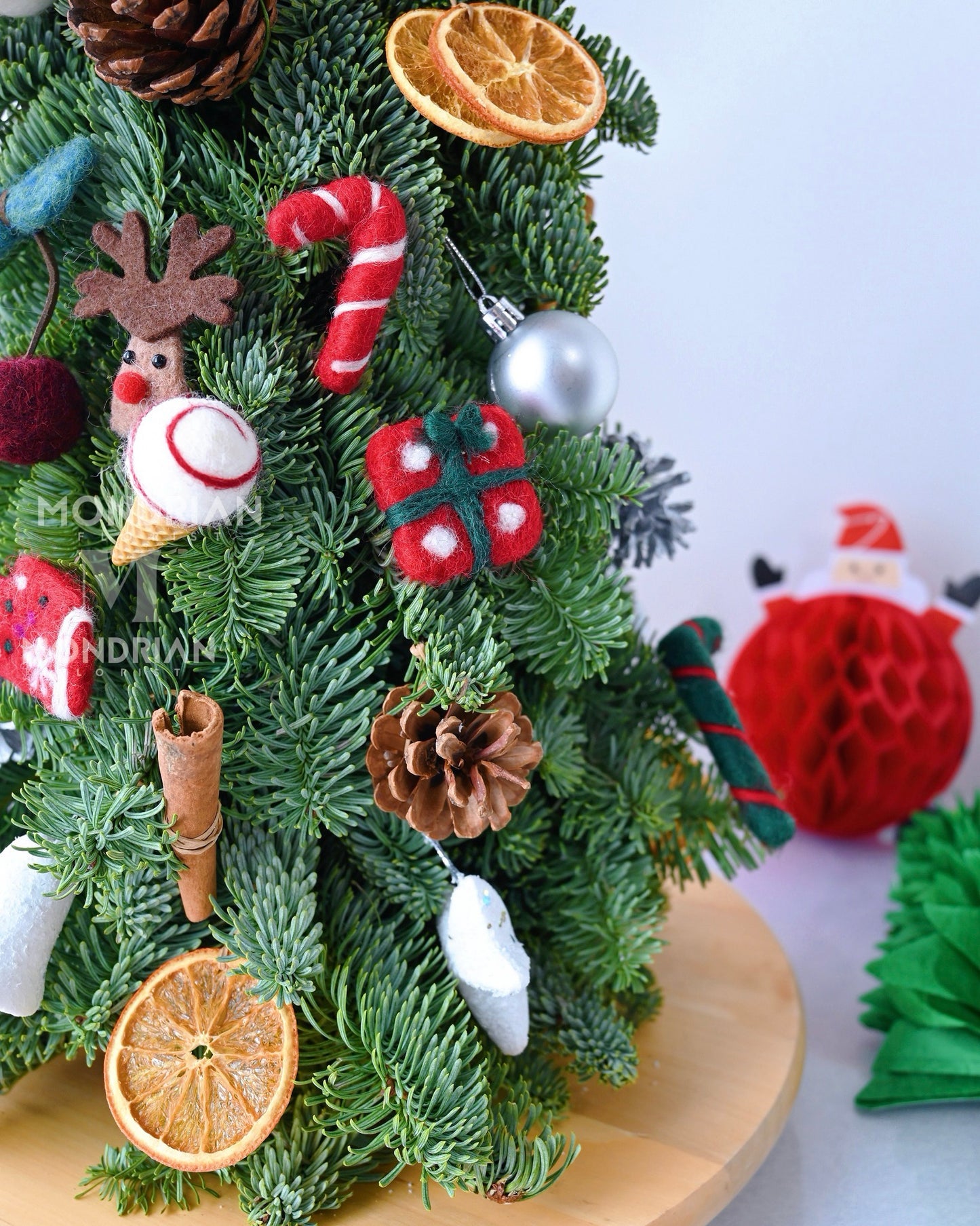 close up of a table top christmas tree with small ornamentals