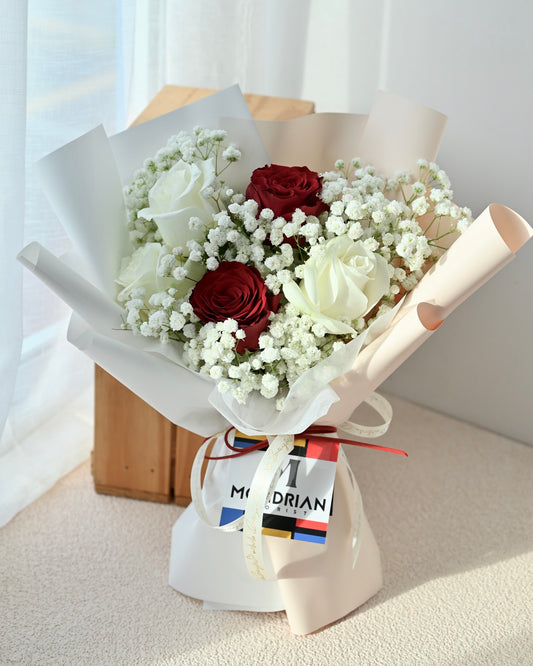 a bouquet of mixed red and white roses with baby's breath by Mondrian Florist SG