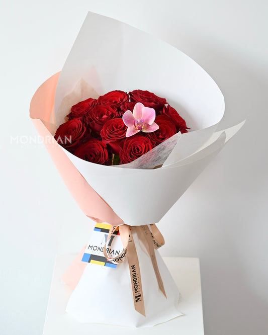 a bouquet of red roses and Phalaenopsis orchid by Mondrian Florist