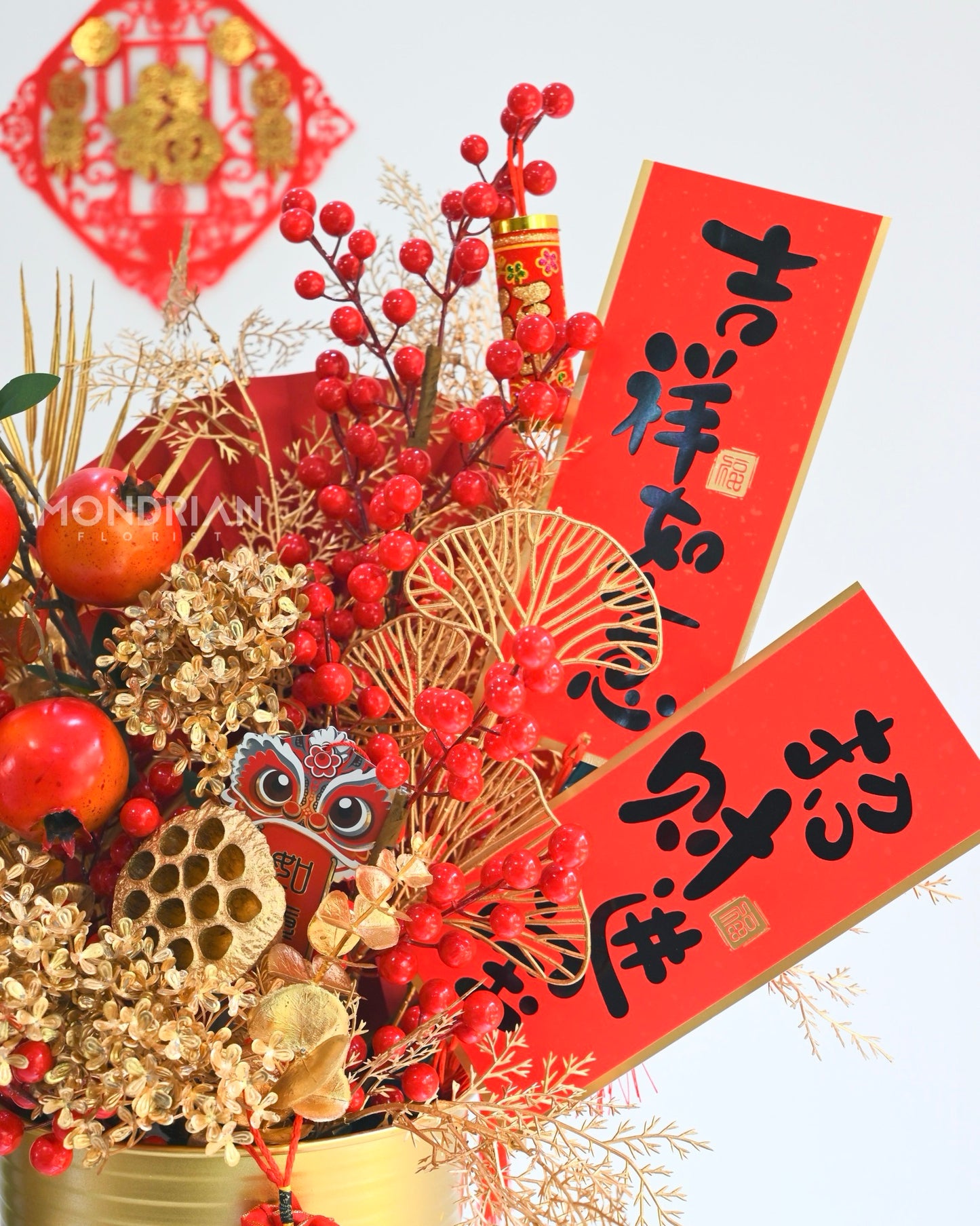 close up of a golden and red theme traditional chinese new year vase arrangement