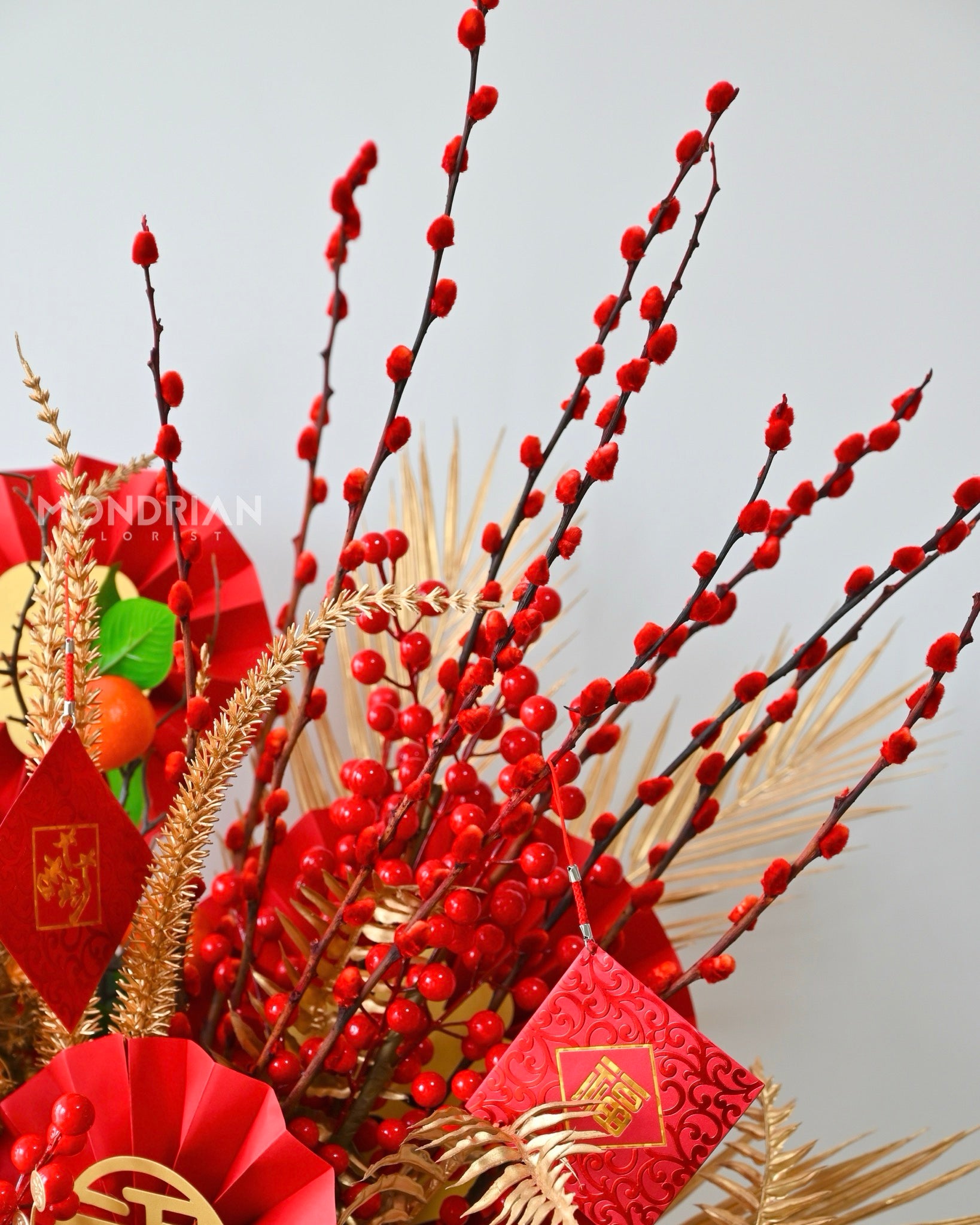 close up of gold and red theme flower box arrangement for chinese new year