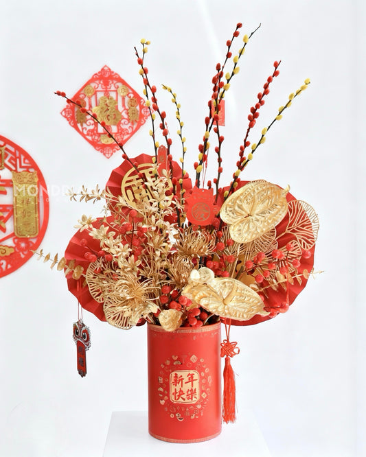 a chinese new year arrangement with red and orange willow buds and golden artificial flowers