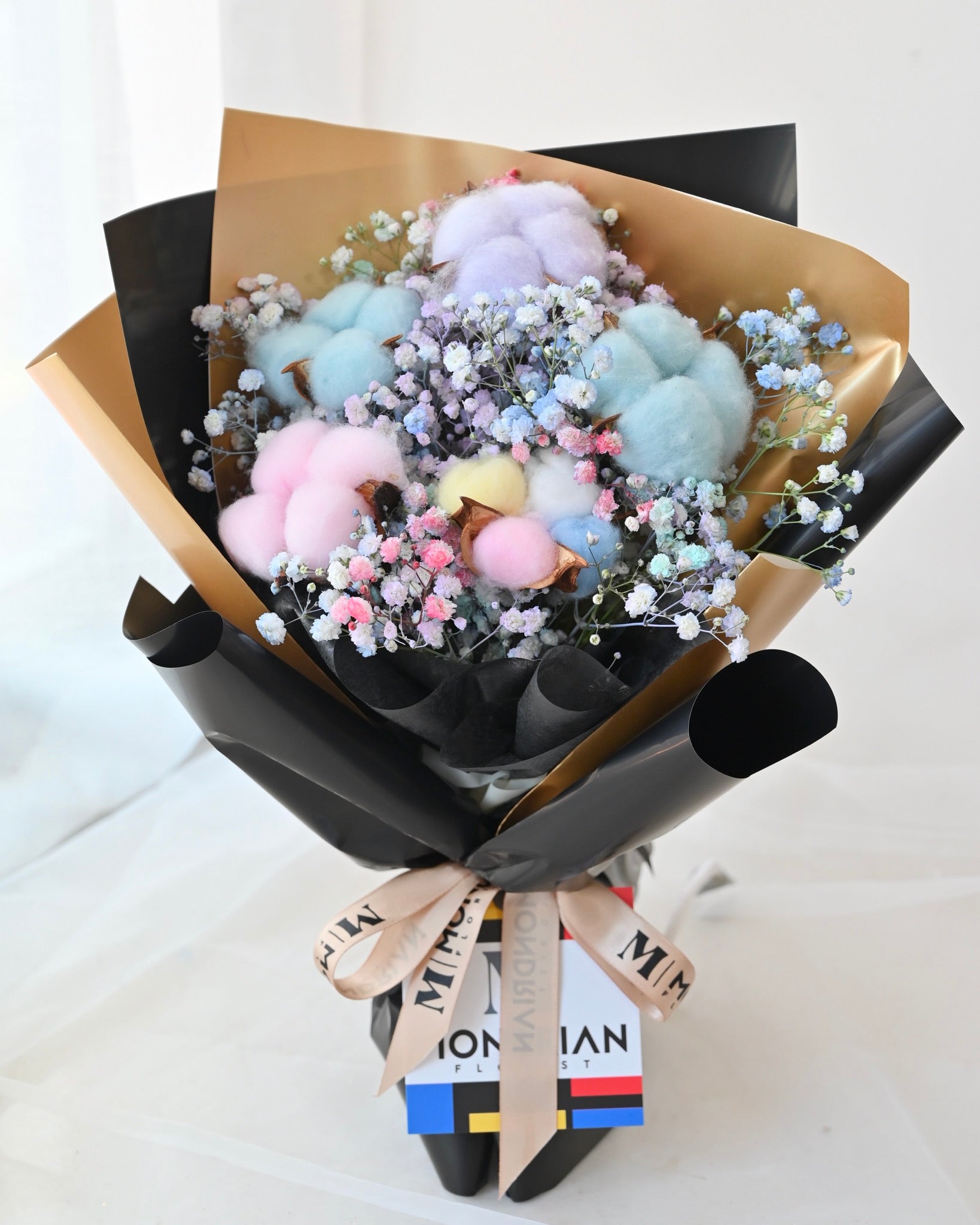a bouquet of rainbow cotton flower and rainbow baby's breath flower