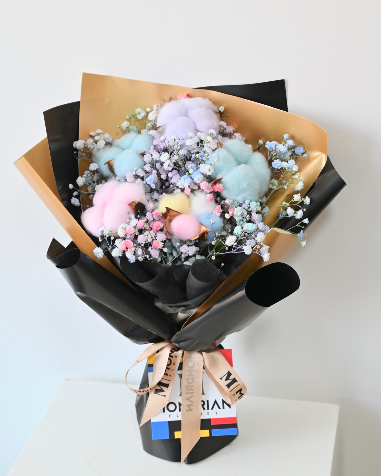 a bouquet of rainbow cotton flower and rainbow baby's breath flower