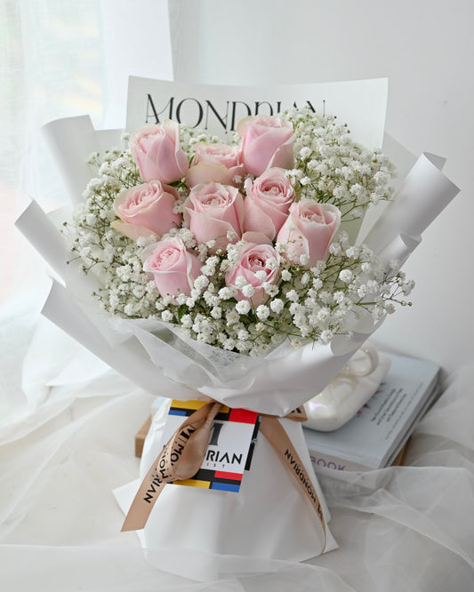 a bouquet of 9 stalks of pink roses and baby's breath by Mondrian Florist