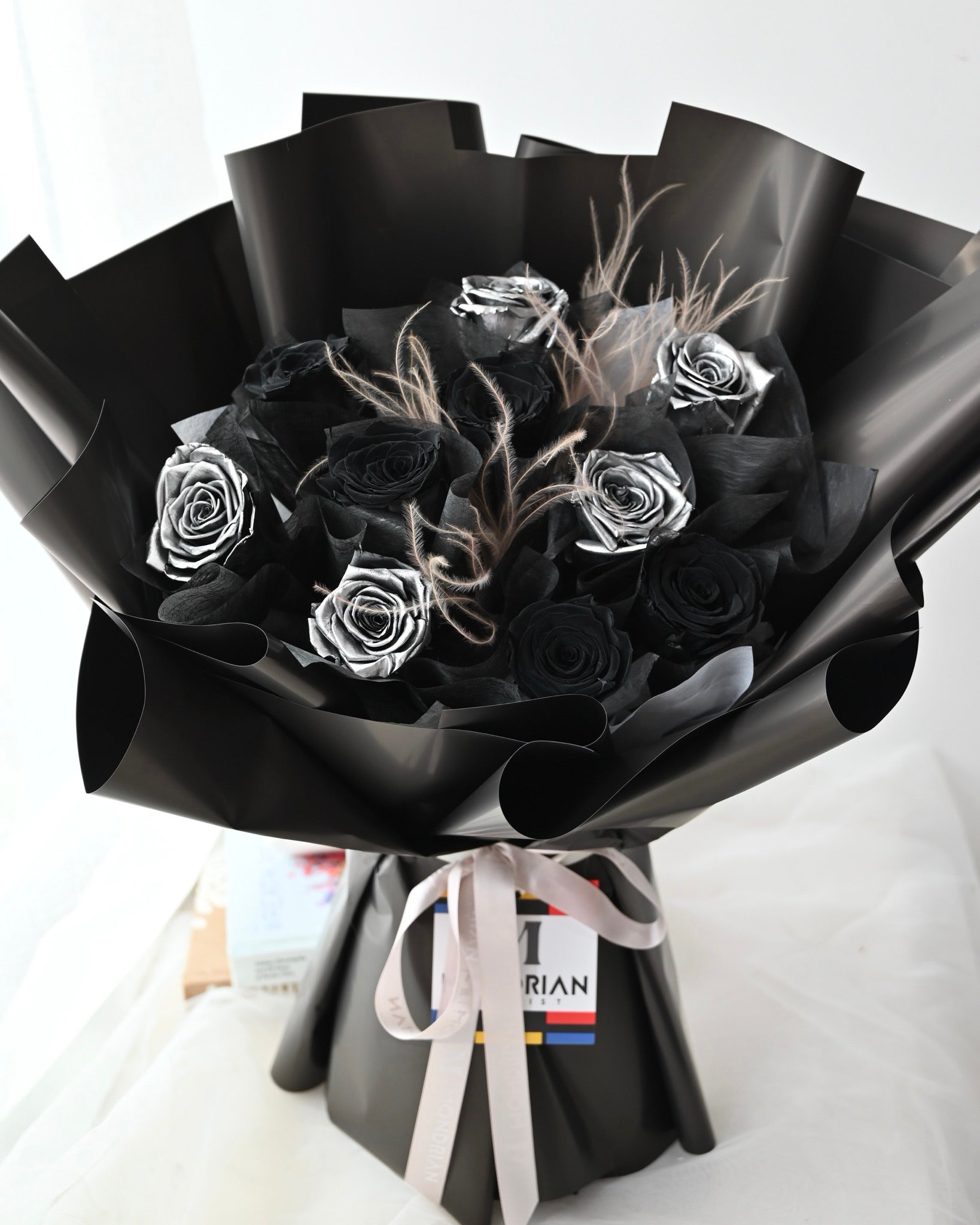 a bouquet with preserved black and silver roses