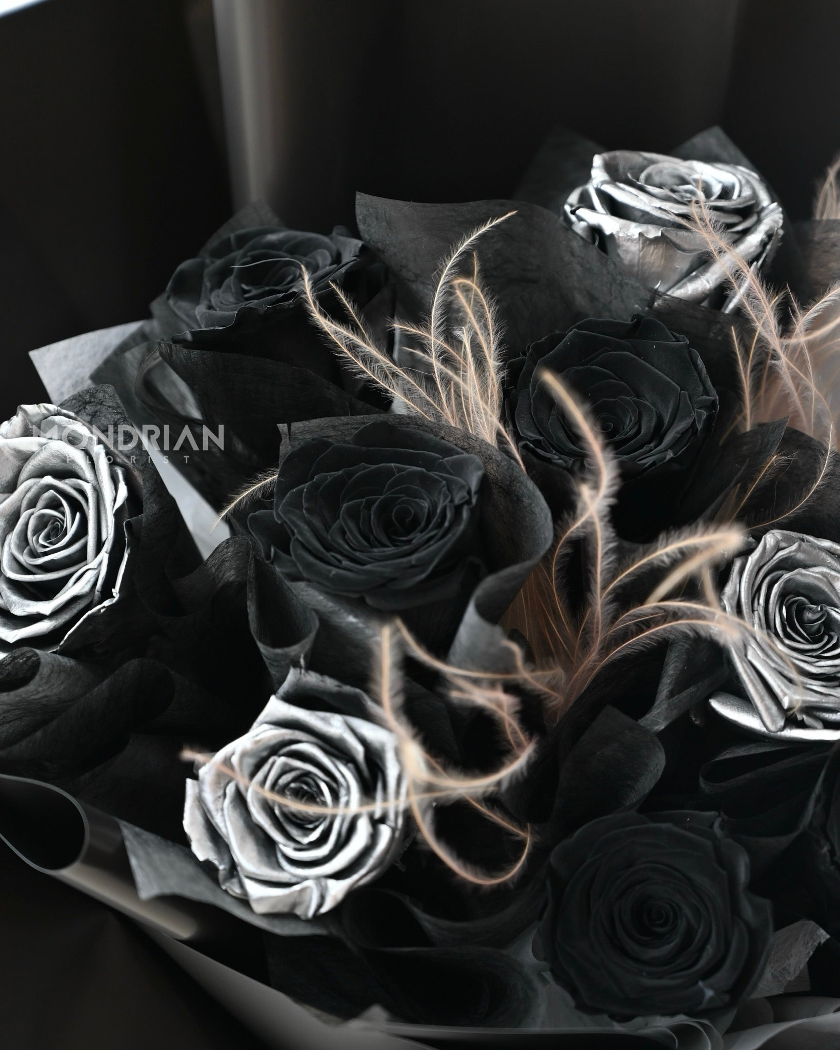close up of a bouquet with preserved black and silver roses