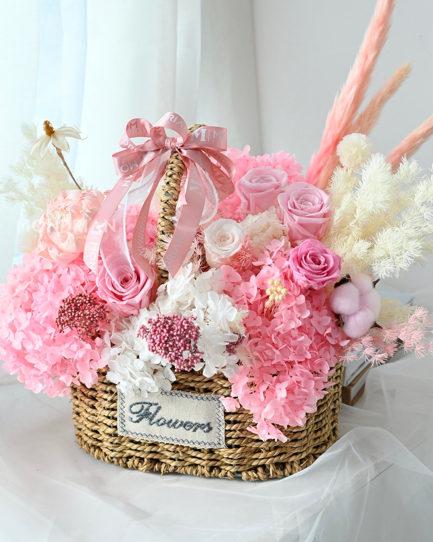 a blooming basket of preserved pink roses and dried pampas grass, romantic feeling