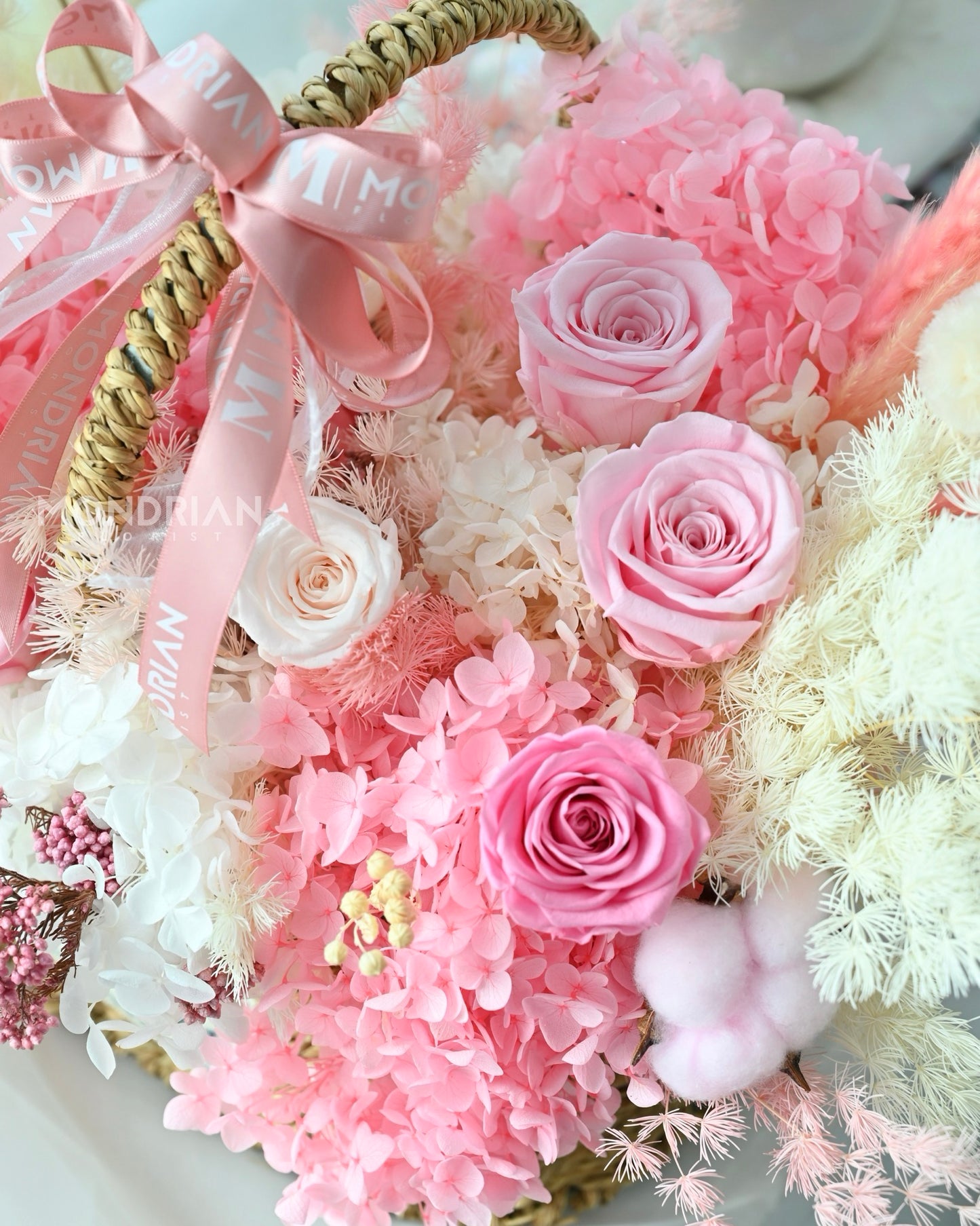 close up of a blooming basket of preserved pink roses and dried pampas grass, romantic feeling