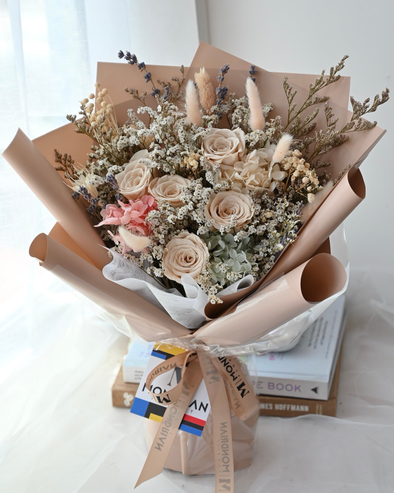 a dried flower bouquet with preserved brown roses