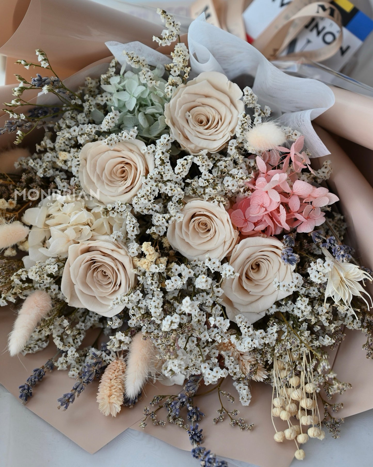 a dried flower bouquet with preserved brown roses