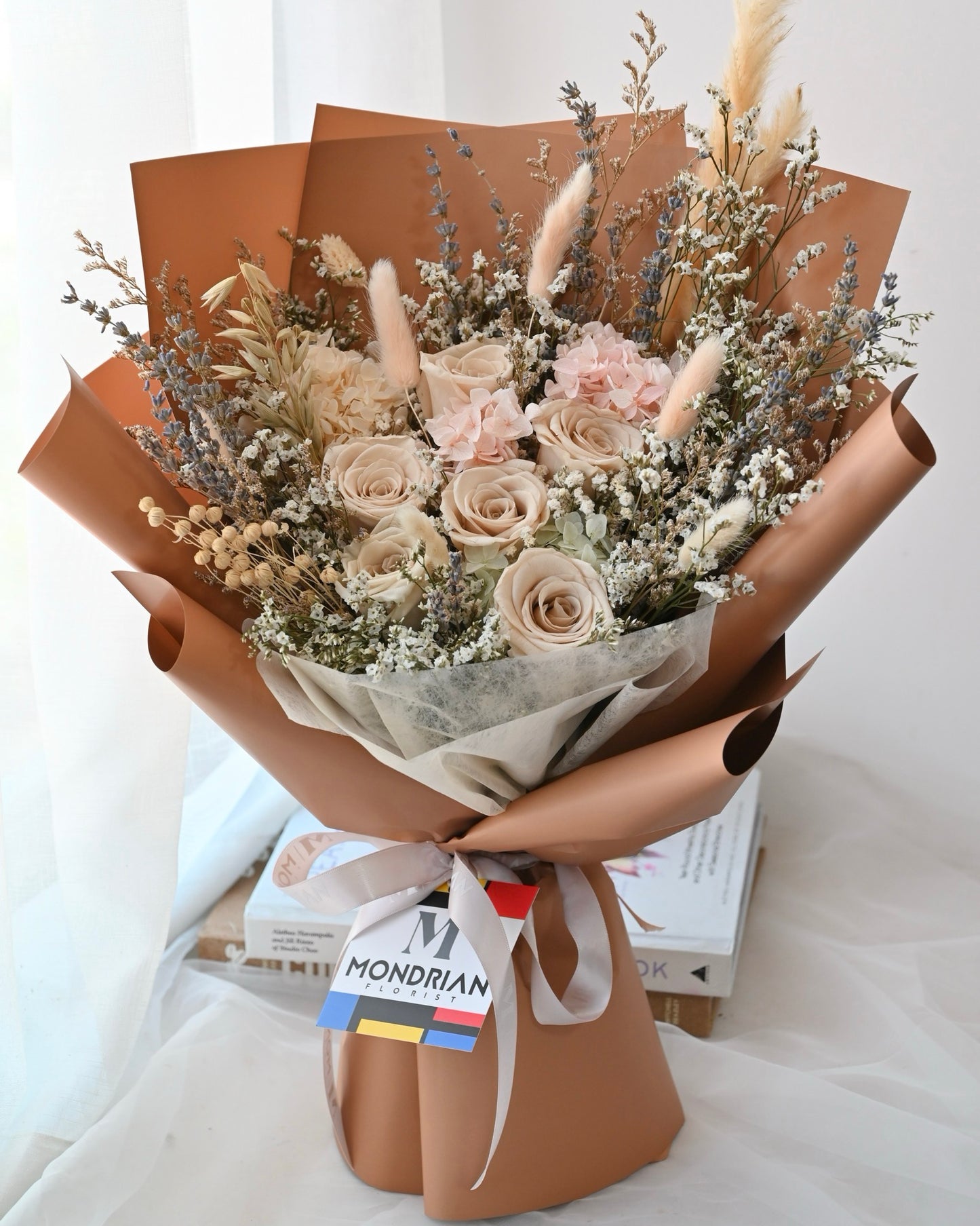 a dried flower bouquet with preserved brown roses