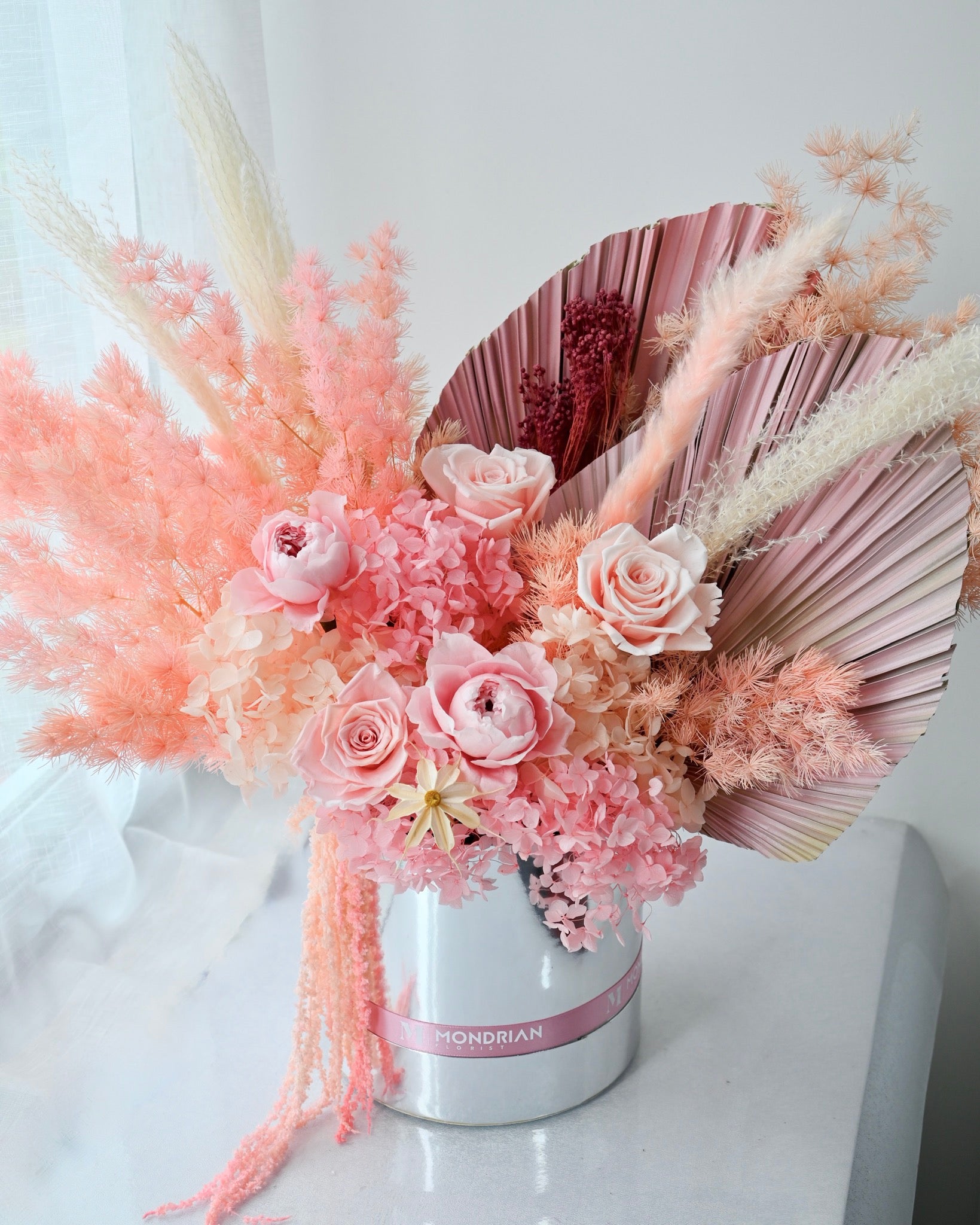 a preserved and dried flower box in pink and coral color