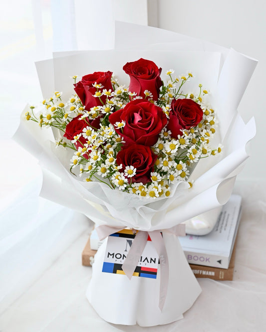 a flower bouquet of red roses and daisy flower by Mondrian Florist