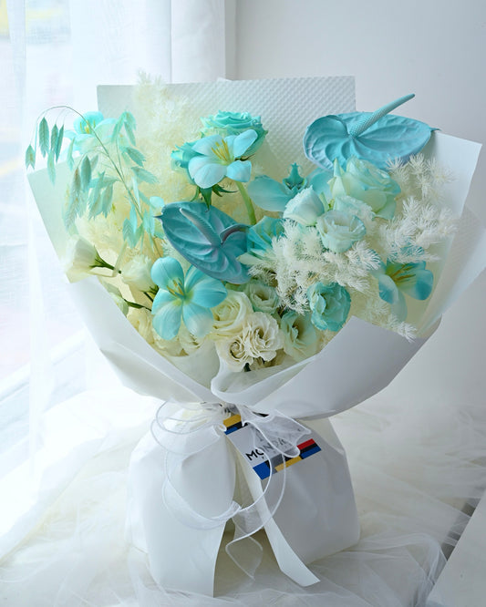 a fresh flower bouquet with tiffany blue roses, tulips and anthurium